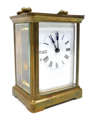 An early 20thC brass carriage clock, rectangular white dial bearing Roman numerals, single barrel movement, stamped ACC, the case of conventional form, with key, 11cm high.