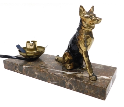 A mid century cold painted brass figural table lamp, modelled as a seated German Shepherd dog, raised on a brown marble base, 22cm wide.