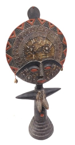 A Ghanaian tribal figural fertility doll, with a circular head, and mannerist torso, raised on a stepped circular base, 63cm high.