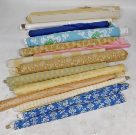 Various bolts of fabric, to include leaf decorated, yellow and blue striped, floral printed, etc. (a quantity)