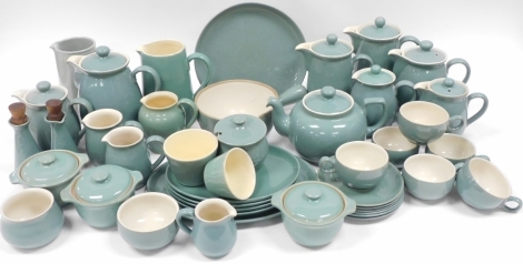 A Denby Manor Green pottery part dinner and tea service, including a teapot, cupboard jugs, saucepan, oval meat platter, tea cups and saucers, etc. (a quantity)