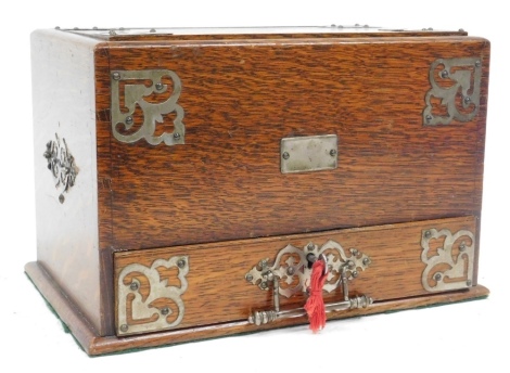 A Victorian oak stationery box, with a bottom drawer opening to release a compartmentalised stationery rack, 20cm x 31cm x 20.5cm.