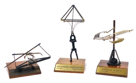 Three 20thC metal sculptures, after Leonardo da Vinci, comprising a Helical Screw, and flying machine, circa 1488, together with a Pyramidal parachute circa 1490, each raised on wooden bases. (3)