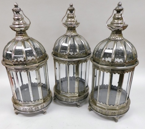 A set of three white metal framed garden candle lanterns, 61cm high.