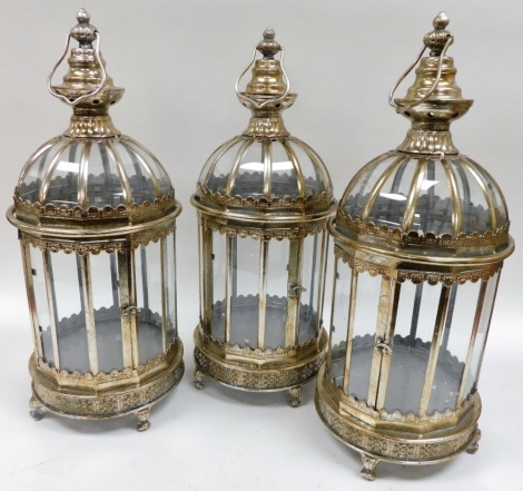 A set of three white metal framed garden candle lanterns, 61cm high.