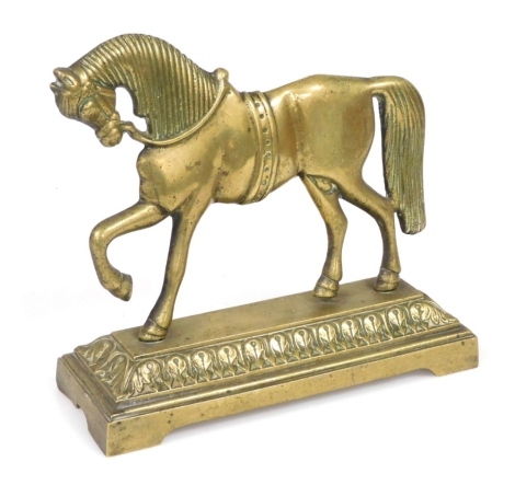 A Victorian brass doorstop cast as a prancing horse, raised on rectangular base, 26cm wide.