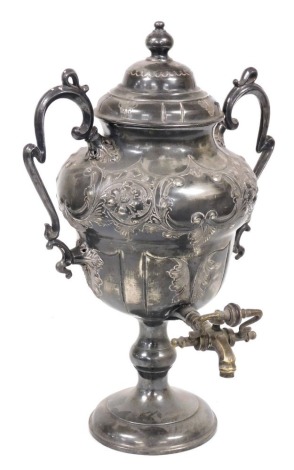 A Victorian silver plated tea urn and cover, of twin handled ogee baluster form, embossed with flowers and scrolling leaves, 38.5cm high. (AF)