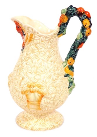 A Clarice Cliff Newport Pottery Harvest ware jug, of baluster form, moulded with fruit and bales of wheat, 23cm high.