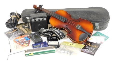 A Tatra Rosetti Stradivarius child's violin, with bow, cased, together with guitar accessories, an Encore guitar amplifier, etc. (a quantity)