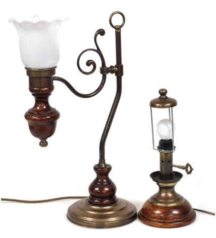 A copper and stained wooden table lamp, with a scrolling arm, holding a frilled glass shade, 47cm high, and a further table lamp, 31cm high. (2) Buyer Note: WARNING! This lot contains untested or unsafe electrical items. It is supplied for scrap or recond