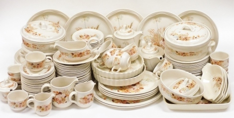 A Poole pottery Summer Glory pattern dinner and tea service, including vegetable tureens and covers, dinner plates, oval meat platters, flan dishes, ramekins, jugs, tea cups and saucers. (a quantity)