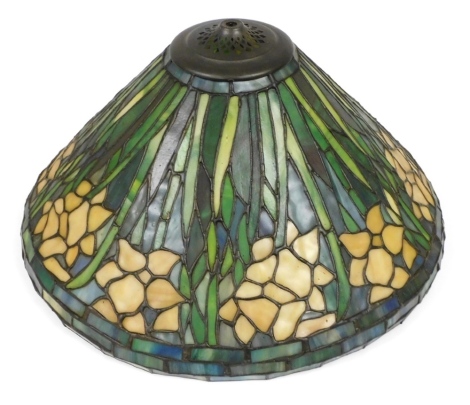 A Tiffany style lamp shade, decorated with repeating flowers and leaves, 43cm wide.