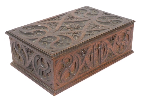 An early 20thC Tudoresque oak box, carved with roses and circular motifs, 41cm wide, 26.5cm deep.