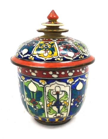 A Thai Benjarong pottery jar and cover, decorated with panels of flowers, within banded borders, 15cm high. (AF)