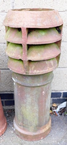 A terracotta chimney stack, of cylindrical form, 94cm high.