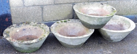 Four composition planters, each of circular tapering form, 50cm diameter.