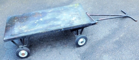 A flat bed trolley on three wheels, the base 40cm x 120cm x 57cm.