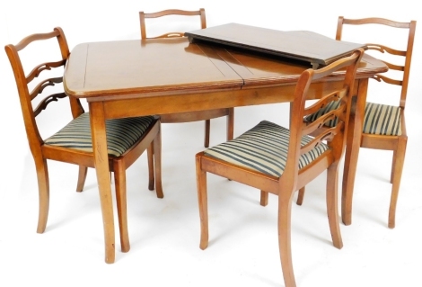 A Strongbow Furniture mahogany extending dining table, the rectangular top with a rounded edge, raised on square tapering legs, 76cm high, 128cm x 79cm, additional leaf 35cm wide, together with a set of four Strongbow Furniture ladderback dining chairs, e