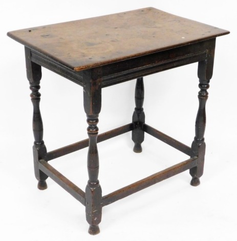 An early 18thC oak side table, the rectangular top raised on turned legs united by stretchers, 71cm high, 73cm wide, 48cm deep.