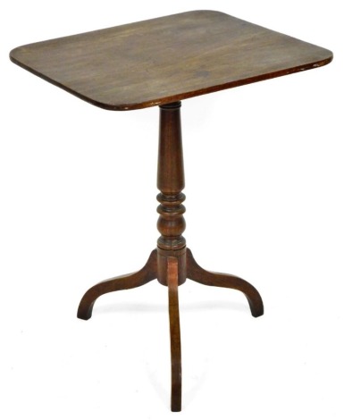 A late Georgian mahogany tilt top occasional table, the rectangular rounded top, on a turned column, raised on three shaped legs, 74cm high, the top 57cm x 48cm.