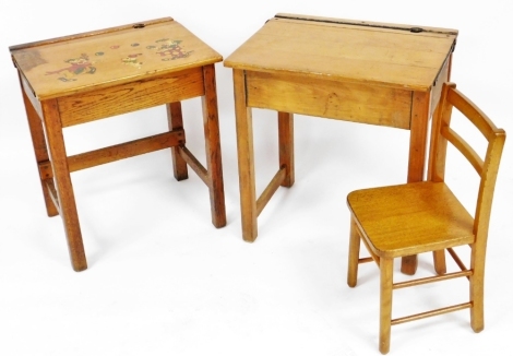 Two 20thC pine school desks, one painted to the top with clowns and a dog, together with an oak child's chair, each desk 56cm wide.