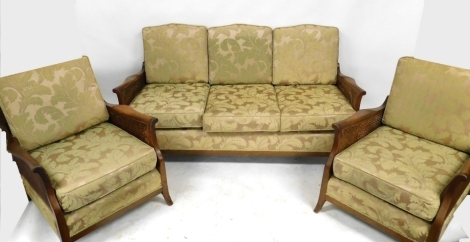 A 1920's three piece mahogany framed bergere suite, comprising three seater settee, 167cm wide, together with two armchairs, later upholstered in pale green leaf decorated fabric.