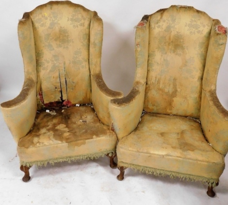 A pair of George III mahogany wing back armchairs, upholstered in gold and turquoise floral fabric, 92cm wide, (AF).