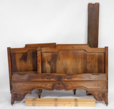 A late 19thC French cherry wood double bed, with panelled head and foot board, and carved sides.