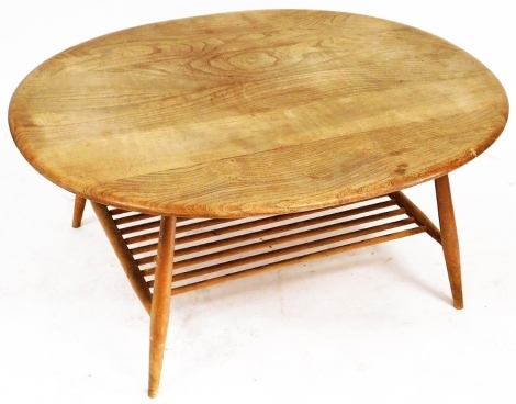 An Ercol light elm oval coffee table, raised on turned legs united by a slatted under tier, 46cm high, 100cm wide, 82cm deep.