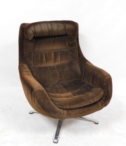 A 1970s Danish swivel egg chair, upholstered in brown draylon, 76cm wide. The upholstery in this lot does not comply with the 1988 (Fire & Fire Furnishing) Regulations, unless sold to a known exporter or upholsterer it will be cut from the frame before le