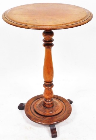 A Victorian mahogany occasional table, the circular top raised on a baluster turned column over a circular base and three scroll feet, 81cm high, 49.5cm wide.