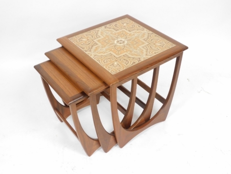 A G Plan teak nest of occasional tables, the largest table with a four tile top, 51cm high, 50cm wide, 51cm deep.