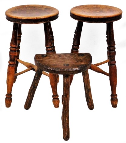 A pair of Victorian oak stools, 53cm high, together with an oak demi lune milking stool, 56cm high. (3)