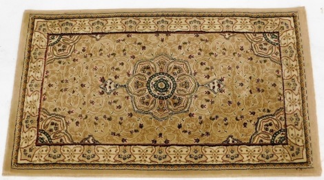 A Heritage Emir beige and ivory rug, decorated with a central floral medallion and foliate tendrils, within repeating floral borders, 80cm x 140cm.