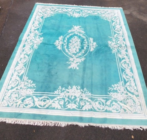 A turquoise ground rug, 305cm x 400cm.