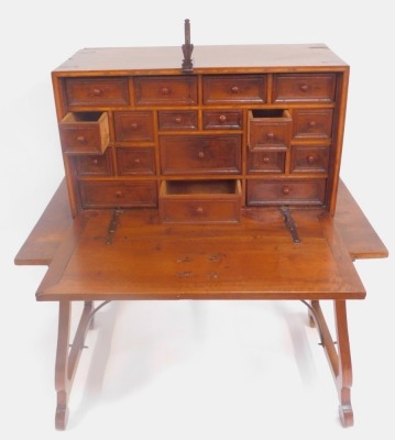 A 17thC Spanish walnut vargueno (or bargueno), having iron strap work and handles, lock plate to the cabinet, with fall flap revealing a combination of moulded panel drawers with knob handles, 53cm high, 91cm wide, 40cm deep, together with an associated p - 2