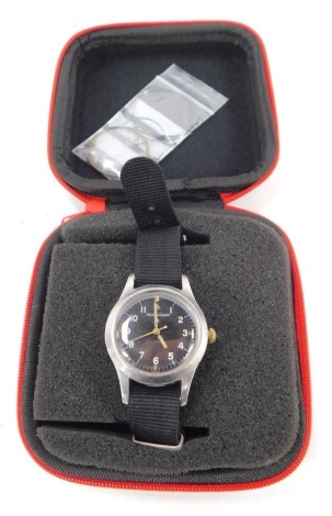 A vintage military Jaeger-LeCoultre gentleman's wristwatch, with a black enamel dial, with white and orange numbered markers, in a stainless steel case, inscribed to reverse Military Arrow 6B-346, 3778-48, B-97, on a black material strap, movement number 