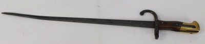 A French St Etienne bayonet, with a walnut and brass handle, with curved hoop stamped FH22471, blade engraved and dated 1879, 65cm long. - 2