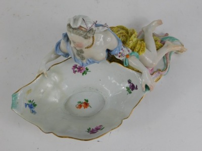 A 19thC Meissen porcelain figural sweetmeat dish, modelled as a partially clad lady holding a large scalloped bowl, polychrome decorated with rococo base, crossed swords mark in blue, 32cm wide. (AF, restored and repaired) - 3