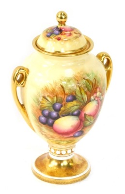 An Aynsley Orchard Gold pattern twin handled vase and cover, painted with fruit by D Jones, with gilt knop handles and rim, with green Aynsley stamp to underside, 23cm high.