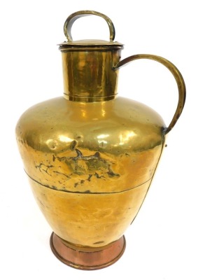 A 19thC brass lidded flagon, with a formed handle and strap top, on a copper foot, 70cm high. (AF)