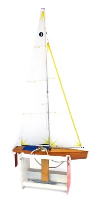 A radio controlled wooden model of a racing yacht Nimbus, with a wooden stand, 100cm, wide.