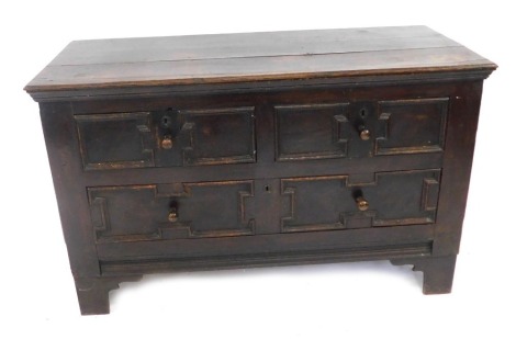 An early 18thC and later boarded chest, of two short and single long drawer, with adapted bracket feet, 131cm wide.