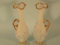 A pair of Victorian white opaque glass ewers