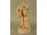 A 19thC bisque porcelain figure of a lady with a putto beside a pedestal
