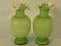 A pair of Victorian green satin glass vases with a frill neck