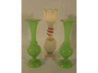 A pair of Victorian green glass vases and a white opaque vase