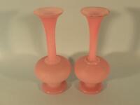 A pair of Victorian opaque pink glass bottle shaped vases