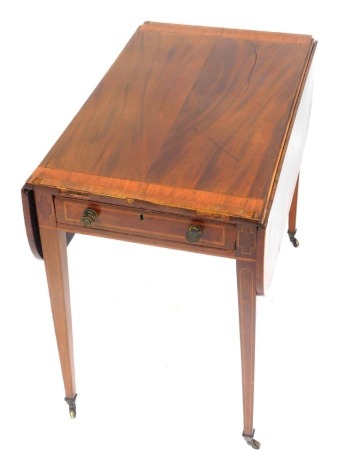 An early 19thC mahogany satinwood and rosewood cross banded Pembroke table, the rectangular top with rounded corners, above a frieze drawer opposing a false drawer, on square tapering legs with castors, 85cm wide.