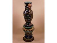 A 19thC Majolica vase decorated in relief with a dragon